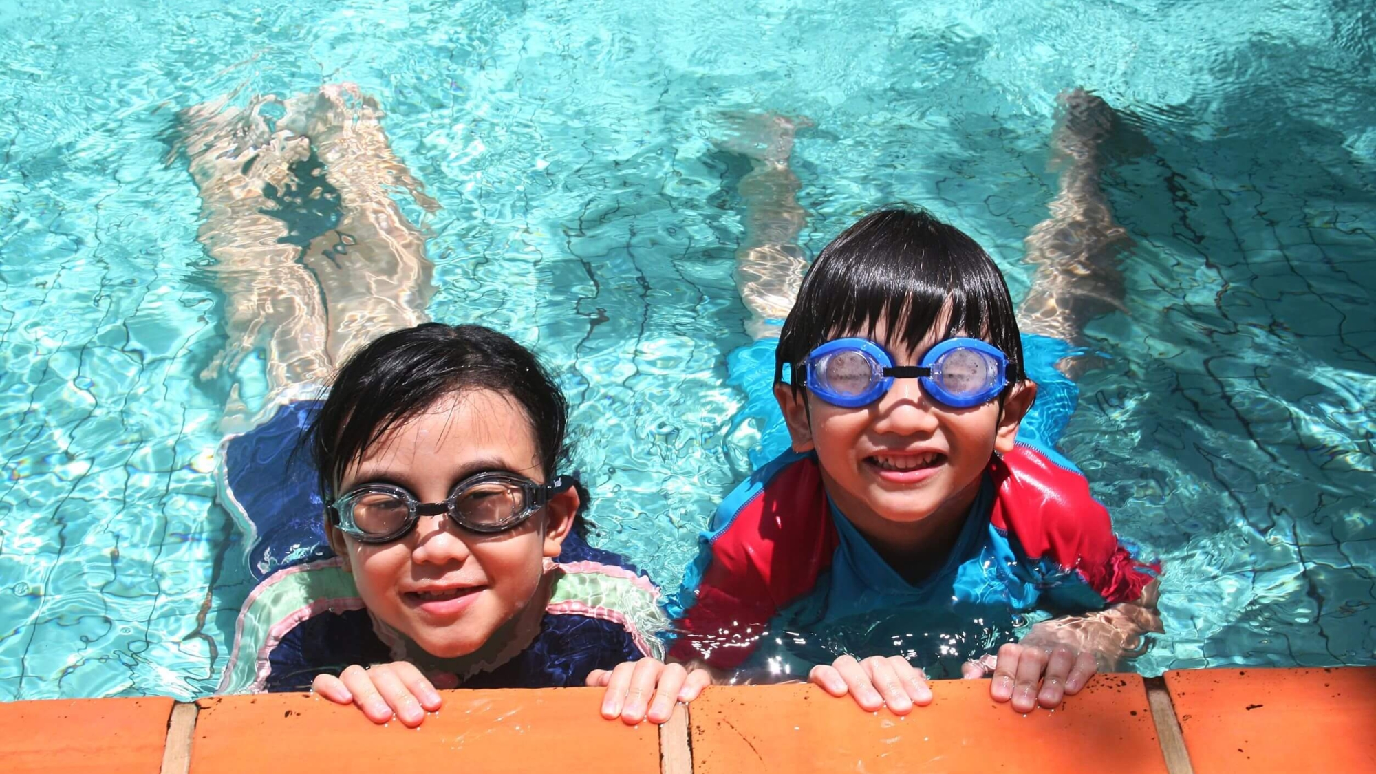 4562281 - kids with goggles in the pool on sunny day