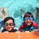 4562281 - kids with goggles in the pool on sunny day