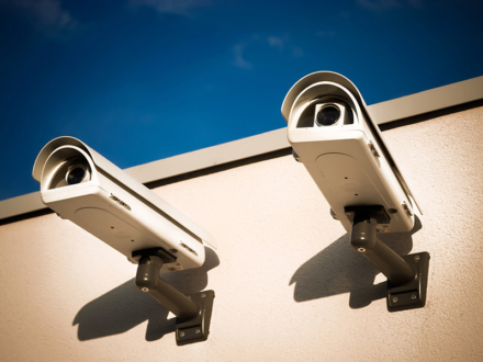 Security video cameras on a wall.